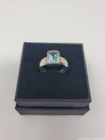 Ring set in black gift box showing stone and band