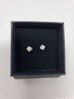 Two square cubic zirconia stud earrings in black gift box