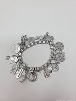 Full view of sterling charm bracelet showing links and multiple charms