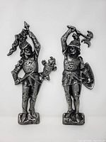 Front view of both cast metal conquistador figures