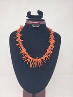 Necklace displayed on bust showing overall design and color