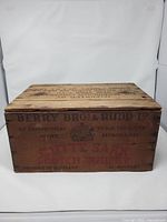 Front view of wooden crate showing main branding text