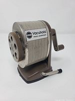 Front angled view showing ADBCO Vacuhold label, metal body, suction base