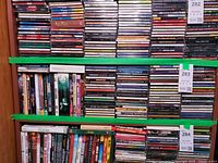 Shelves filled with stacks of jewel-case CDs