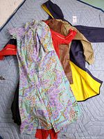 All six garments layered on blanket