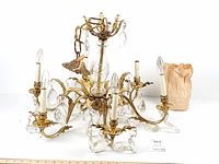 Full view of chandelier with arms, sockets, crystals, bag of pendants