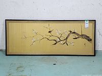 Full view of framed artwork showing cherry blossom scene on gold background