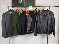 Front view of all five jackets hanging on rack