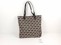 Front view of tote showing monogram pattern and shape