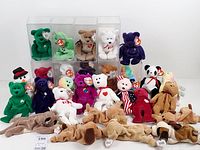 Overview of entire lot showing bears in cases, loose bears, rabbit, snowman and dogs