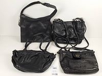 Group shot of four black leather handbags