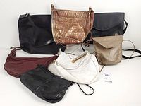 Group shot of all seven leather bags displaying variety of colours and styles