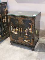 Front and left angle showing doors with inlay and glass top