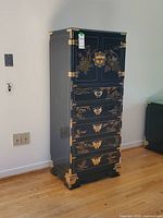 Full front view of dresser showing doors, drawers, brass hardware and painted motifs