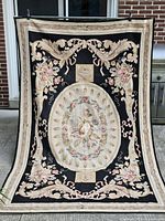 Full front view of entire needlepoint rug showing design and colors