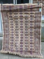 Full view of hanging rug showing overall design and fringe