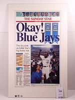 Front view of plaque showing entire newspaper front page