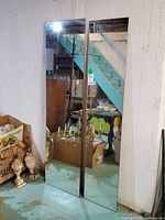 Both mirrors leaning against wall showing full size and frameless design