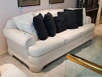 front angled view showing sofa shape, upholstery and cushions