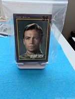 Plastic bag holding stack of Star Trek cards, front card Captain Kirk Court-Martial