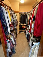 Full view of walk-in closet with garments on both sides