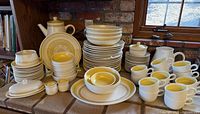 Full set displayed on counter showing quantity and variety of dinnerware pieces