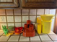 Full lot on counter showing variety of multicolored plastic kitchenware