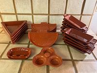 Full set showing stacks of triangular, semicircular, rectangular dishes plus two condiment servers