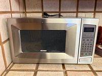 Front view of Kenmore stainless steel microwave on countertop