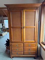 Full front view of Ethan Allen cabinet showing doors, drawers, hardware, and overall style