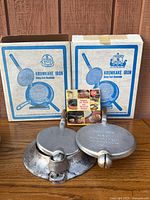 Two Nordic Ware irons, boxes, and booklet overall view