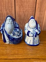 Front view of both Eldreth Pottery Santa figurines showing overall design and salt glaze