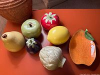 all seven ceramic fruit pieces on table