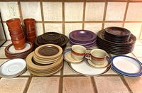 overview of all assorted stoneware plates, cups and bowls
