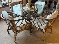Overall view of round glass top bamboo table with four matching chairs