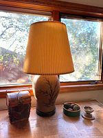Lamp, picnic basket, faux figs bowl, stoneware bowl on window ledge