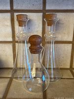 Front view of all three decanters showing shapes and stoppers
