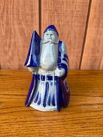 Front view of salt-glazed Santa figurine showing tree and robe details