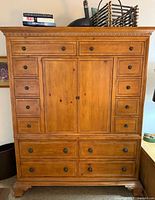 Full front view of Ethan Allen dresser-media cabinet showing drawers, doors, feet