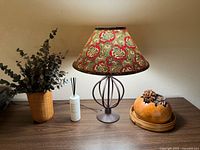 Overall lot view: lamp, diffuser, wicker vase with eucalyptus, pinecone bowl on table