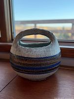 Front view showing basket shape, stripes and handle