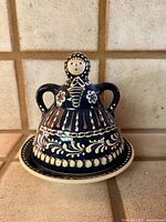 Front view showing lady-shaped domed cover and underplate with hand-painted floral pattern