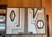 Full view of framed Navajo weaving showing overall pattern