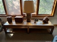 Top and front of rectangular Lane patchwork coffee table below window