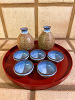 Full set on red tray: two flasks, six cups