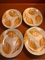 Set of four matching hand-painted leaf plates