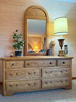 Full view of dresser with attached arched mirror and hardware