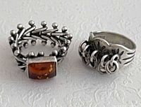 Both sterling rings side by side showing designs and amber stone