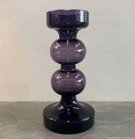 Full frontal view showing entire purple glass vase/candleholder