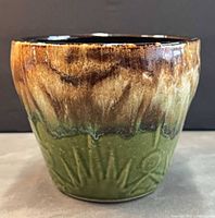 Front view showing drip glaze and embossed pattern